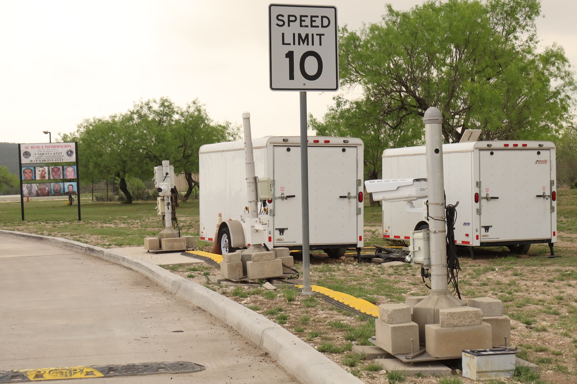 ALPR cameras next to white trailers along the lane into a checkpoint